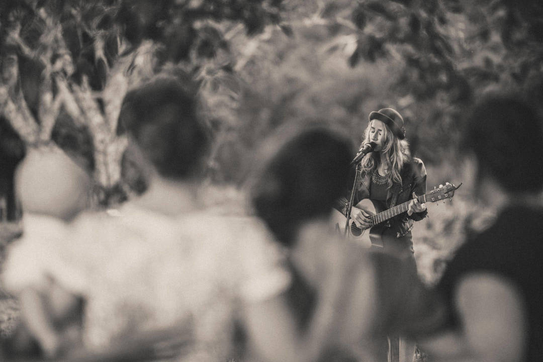Bella Maree Music black and white image girl holding acoustic guitar singing for wedding